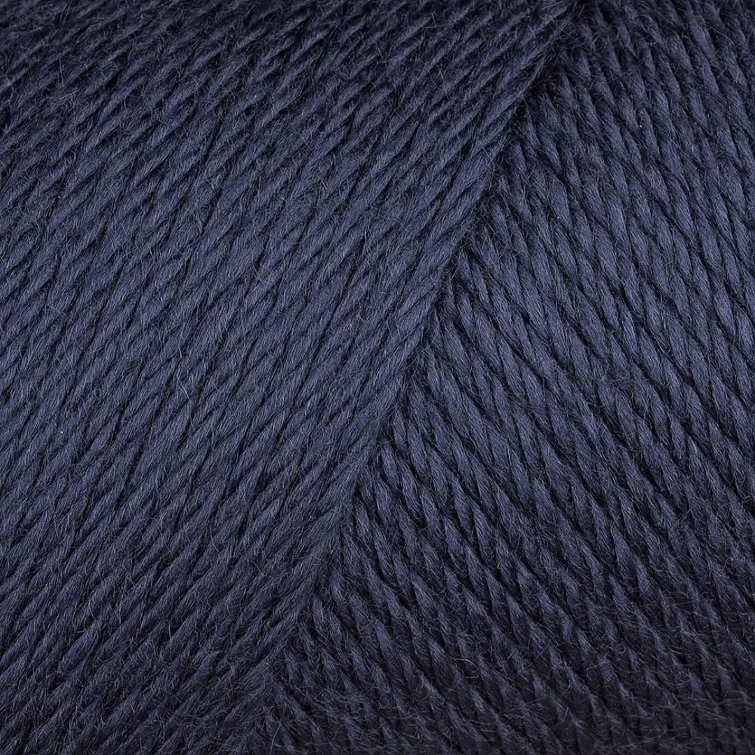 Close-up picture of navy blue Caron Simply Soft aran yarn.