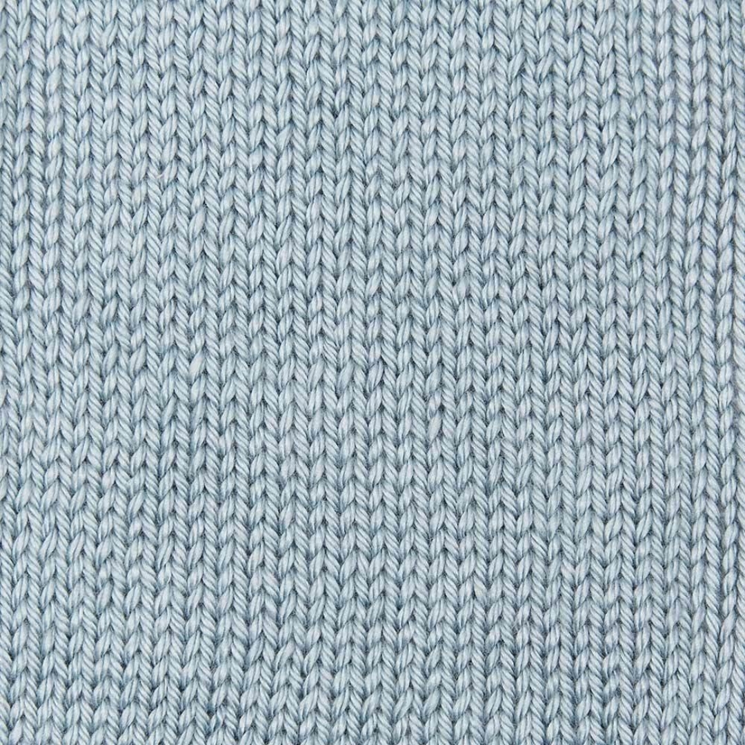 Handknit swatch of light blue Caron Simply Soft aran yarn.
