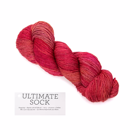 A hank of bright red Malabrigo Ultimate Sock yarn.