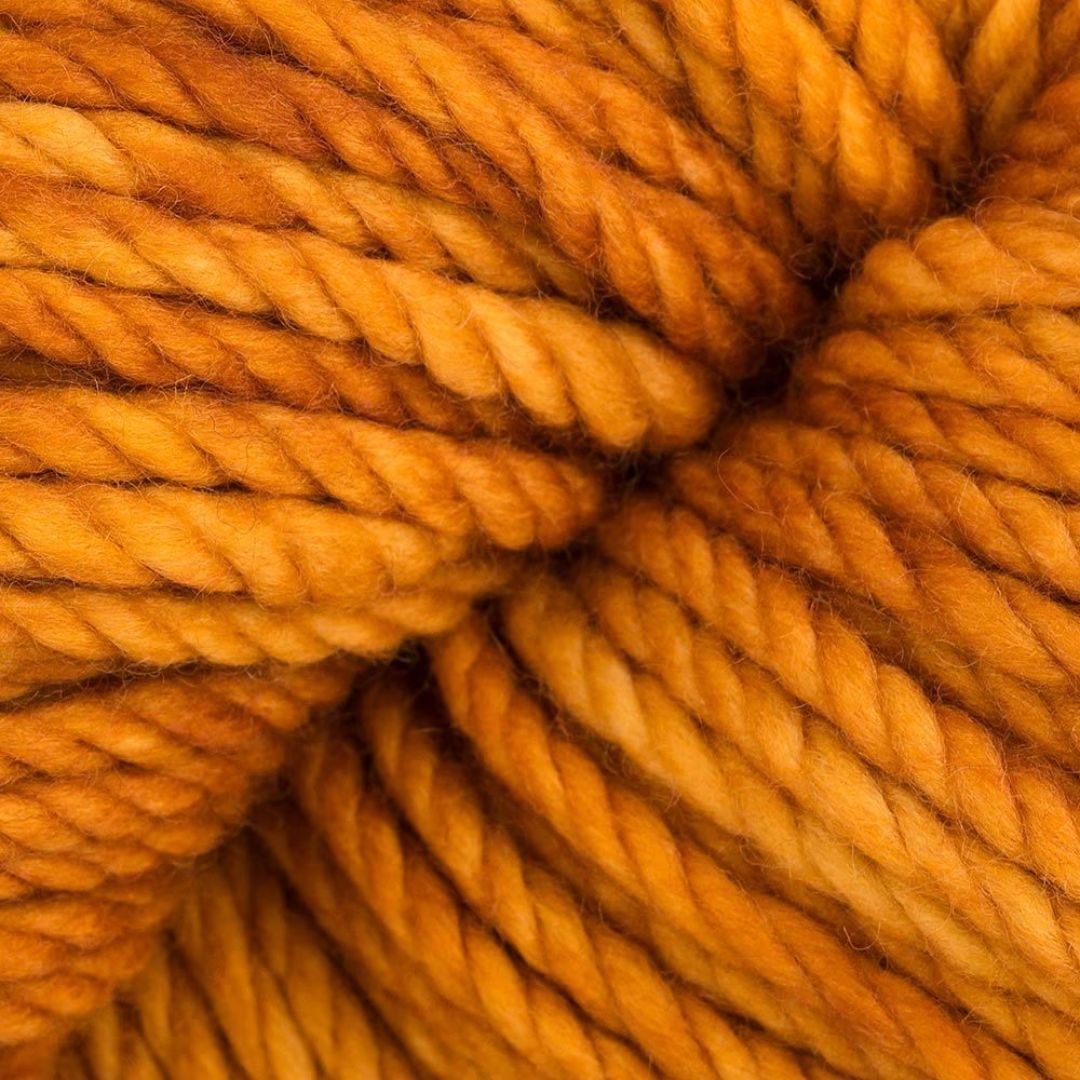 A close-up of orange yarn.