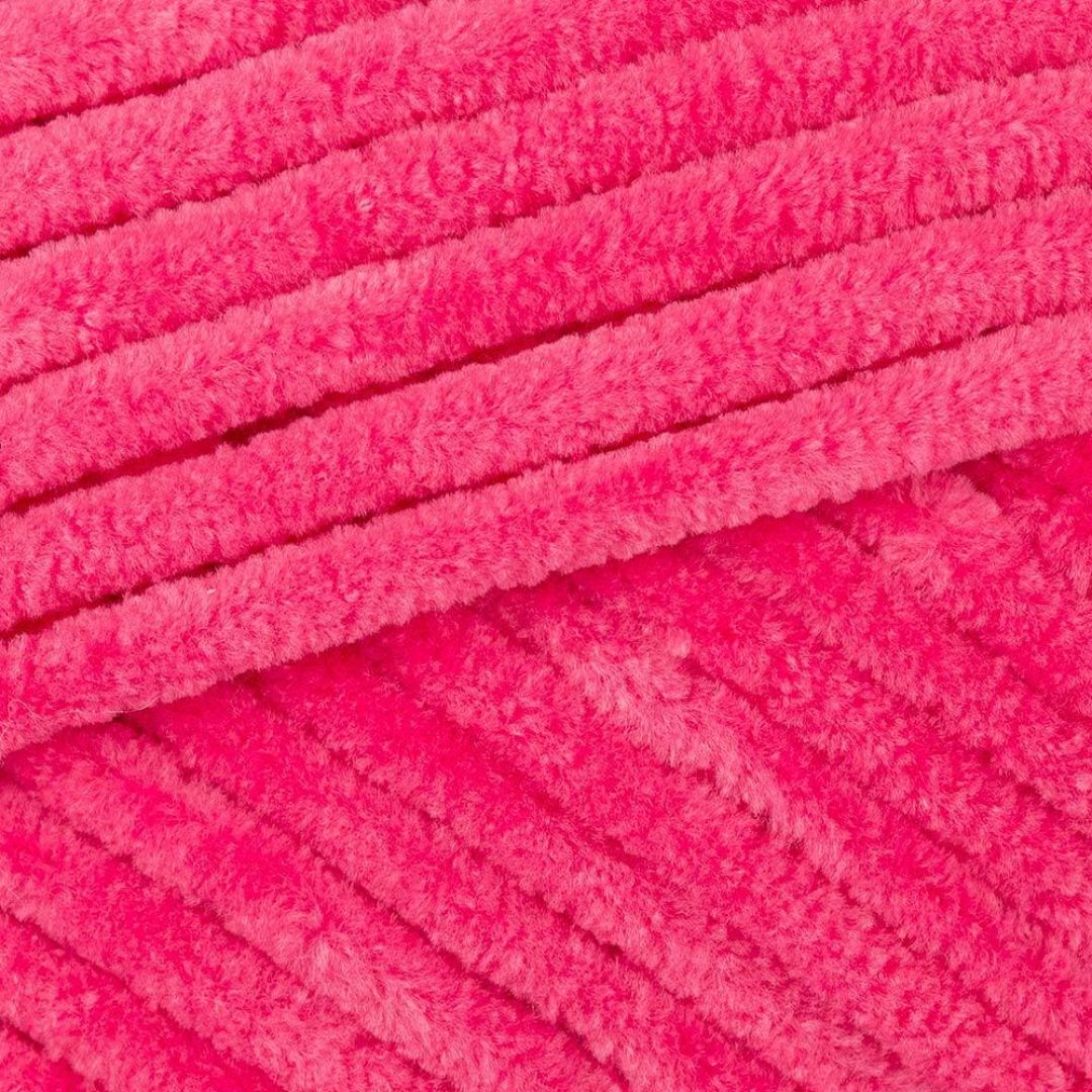 A close-up of fuzzy hot pink yarn.