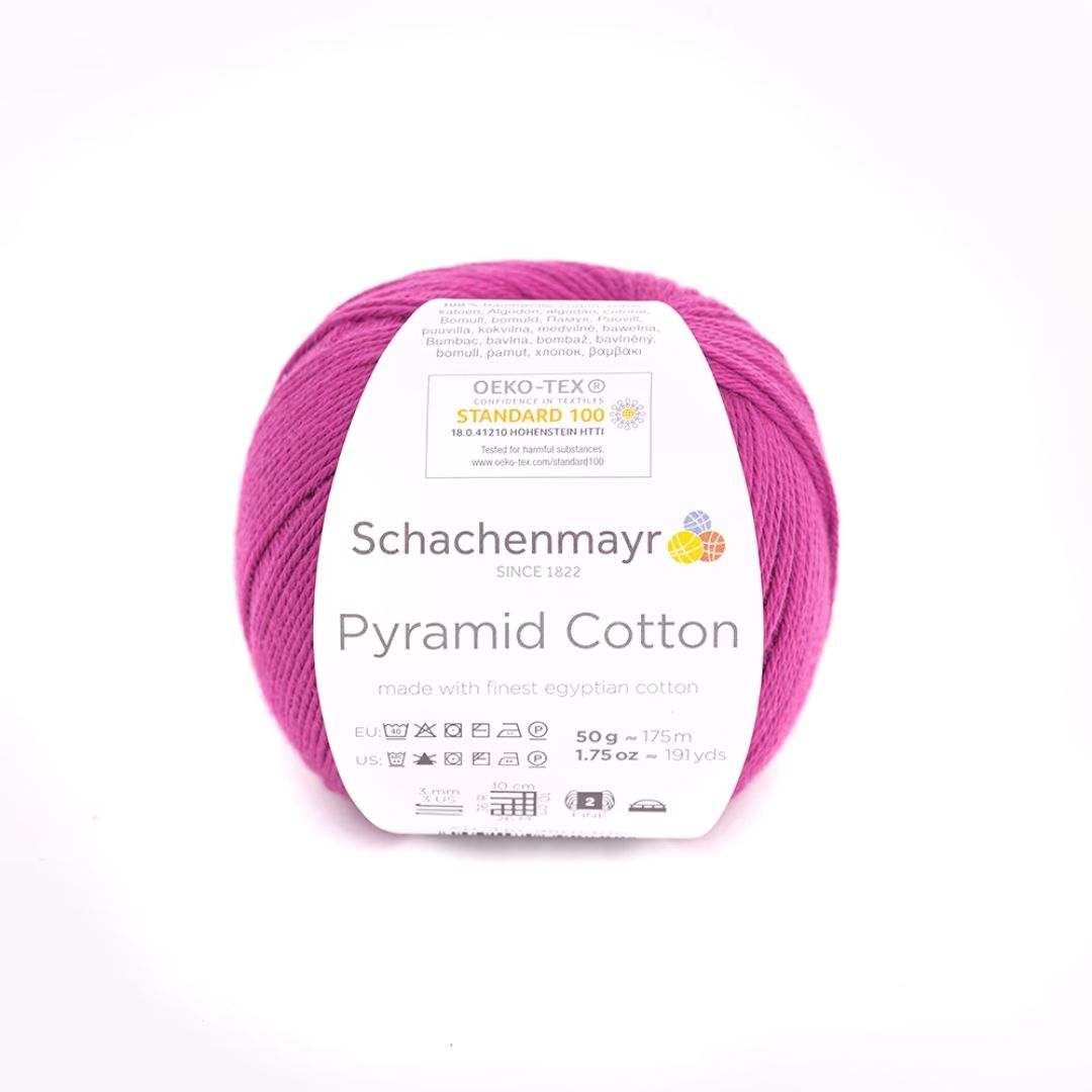 A ball of magenta Schachenmayr Pyramid Cotton yarn.