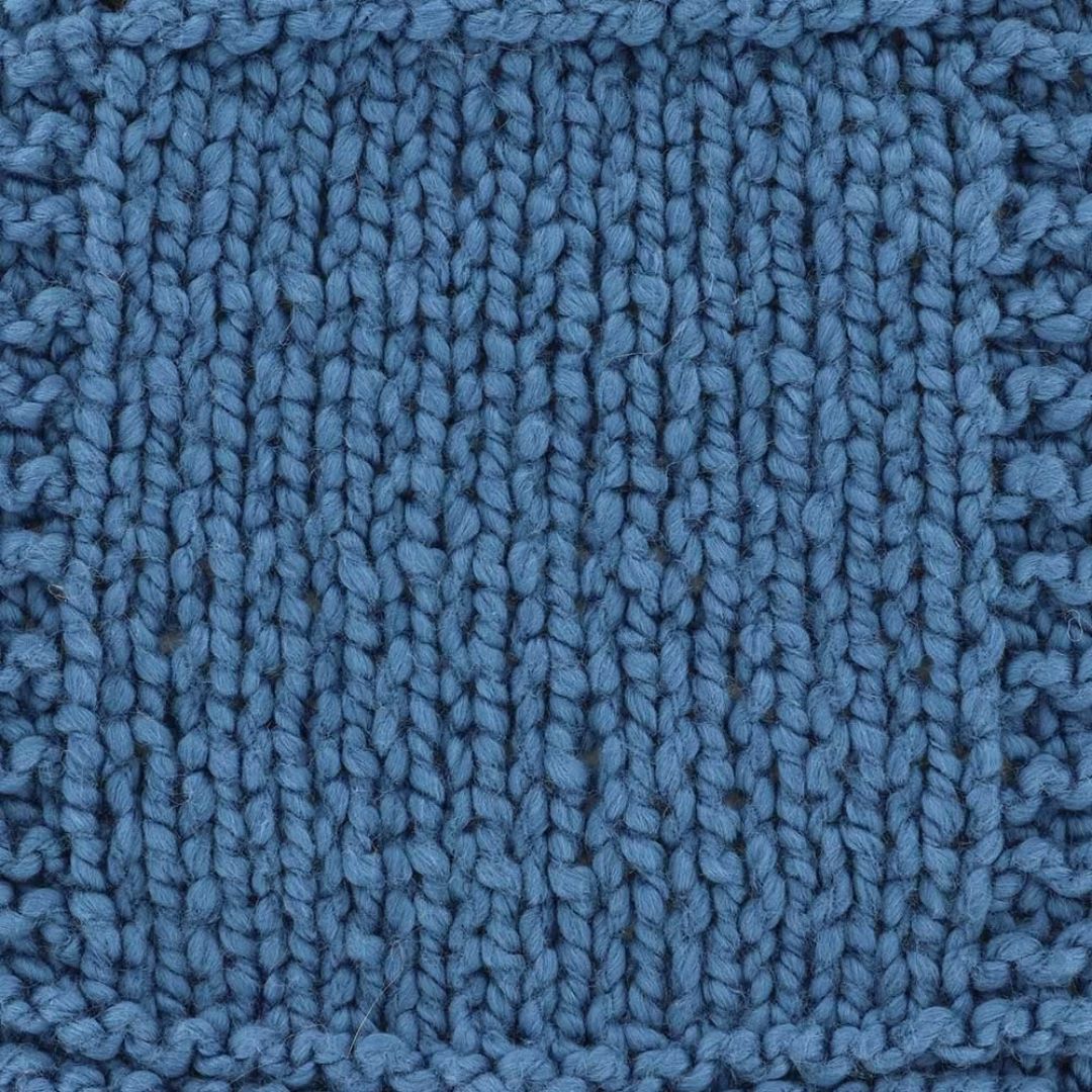 A knit swatch of a deep blue yarn.