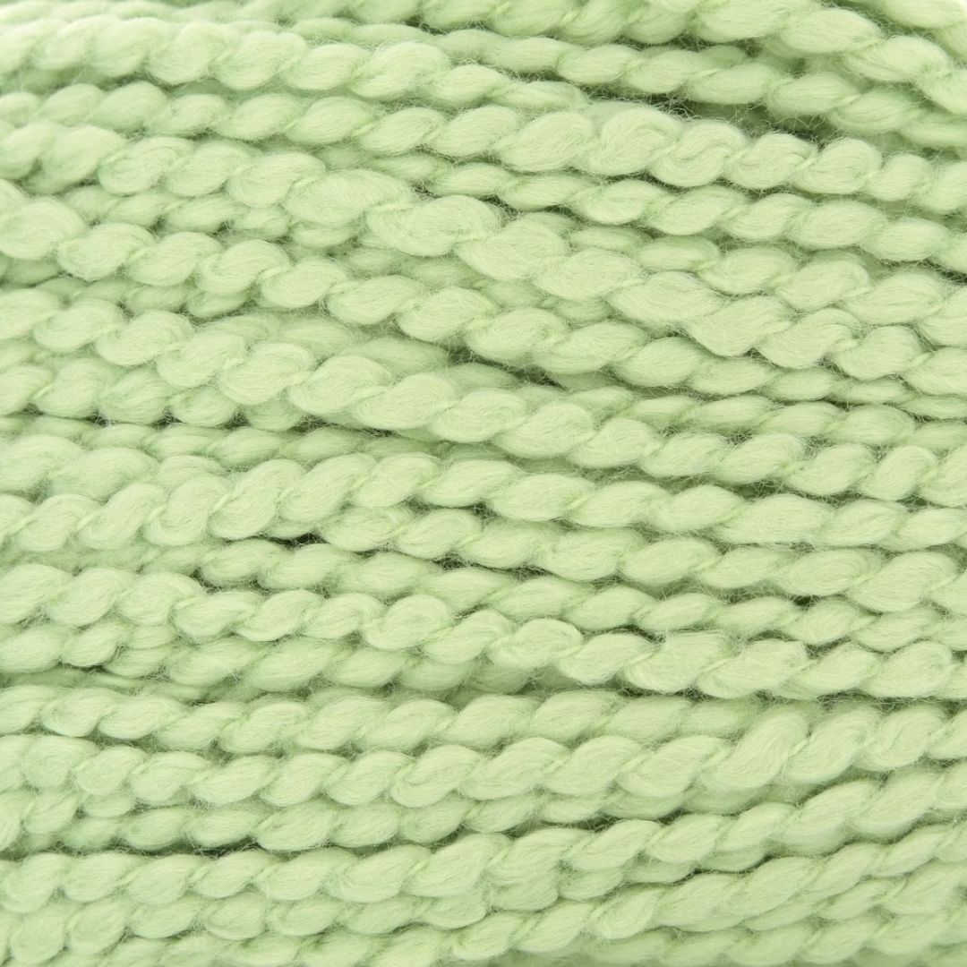 A close-up of soft green yarn.