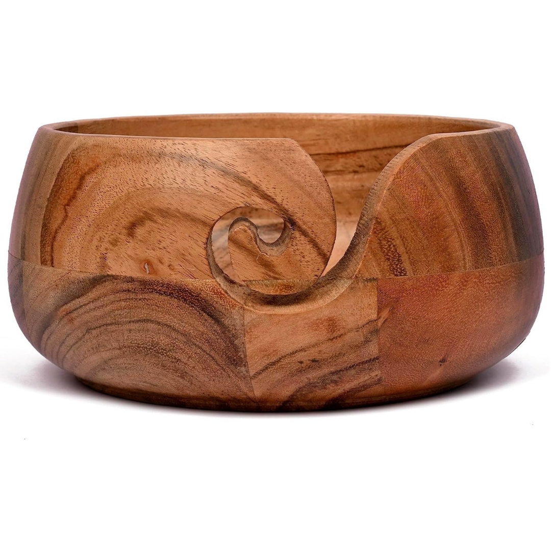 A light brown wooden yarn bowl with a swirl cut through the side to put your yarn through.