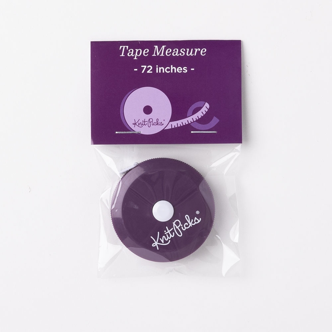 A purple KnitPicks brand tape measure, still in the plastic packaging.