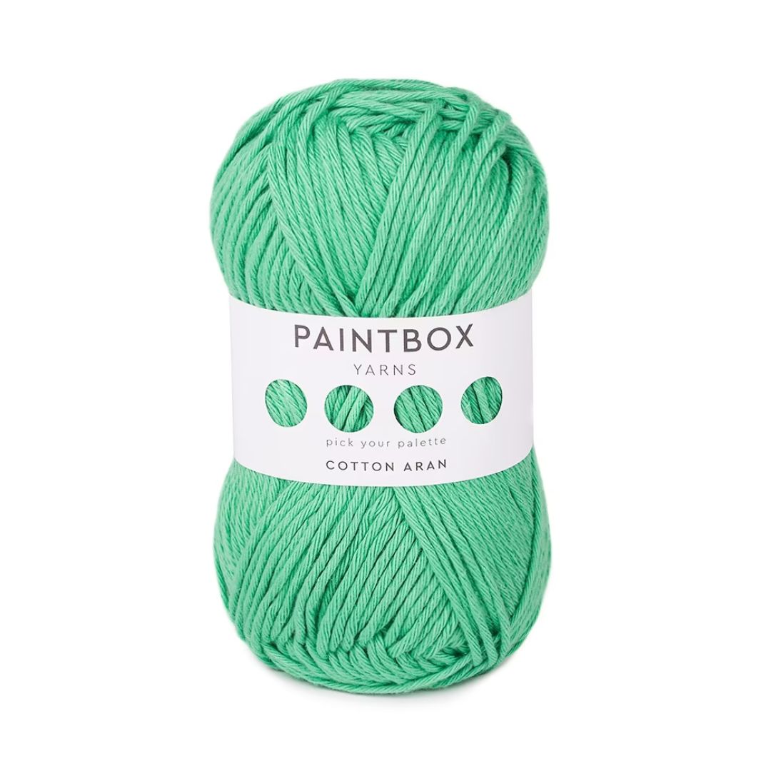 A ball of green Paintbox Yarns Cotton Aran yarn.