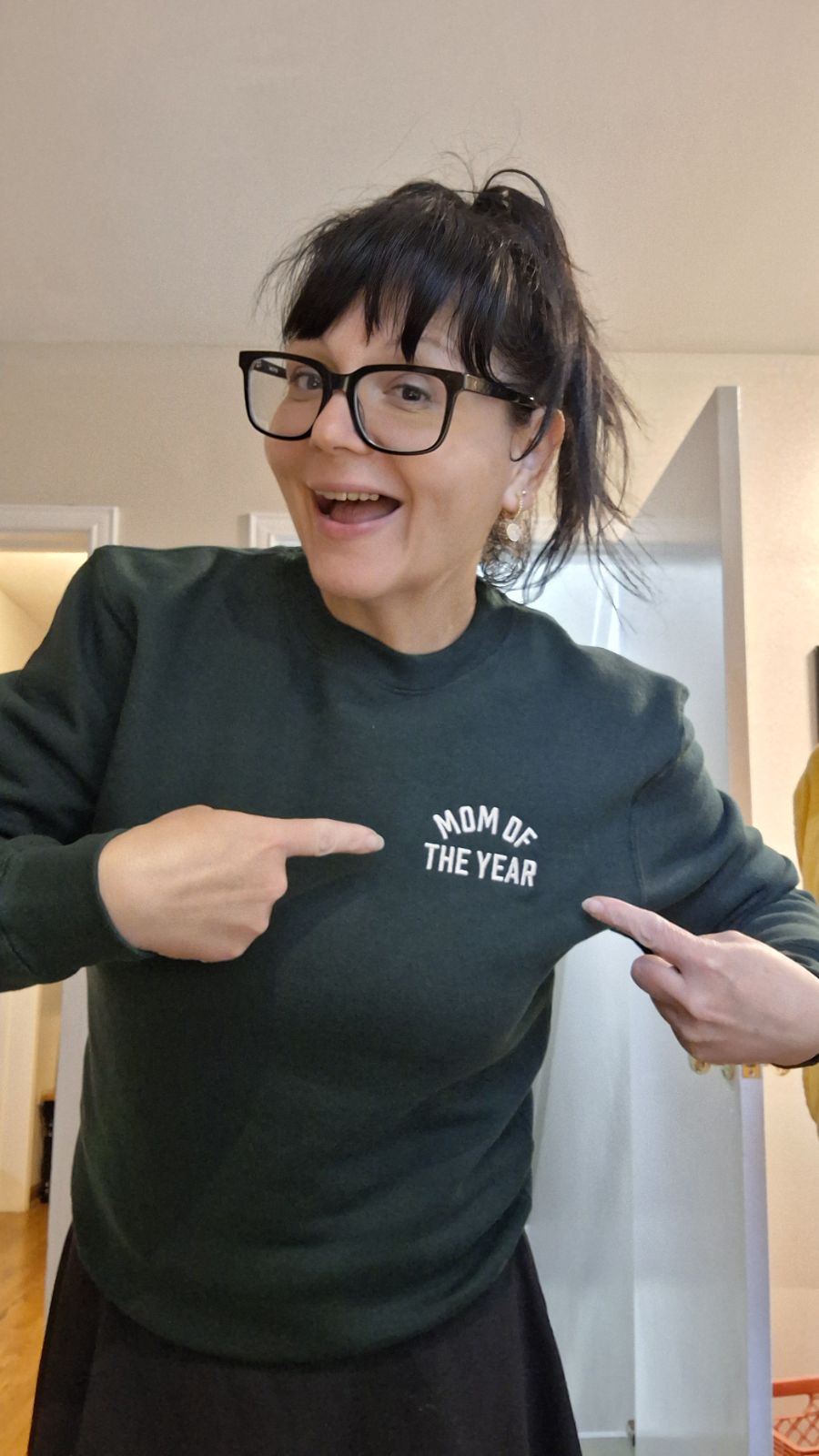 A cheerful Mom of the Year sweatshirt moment