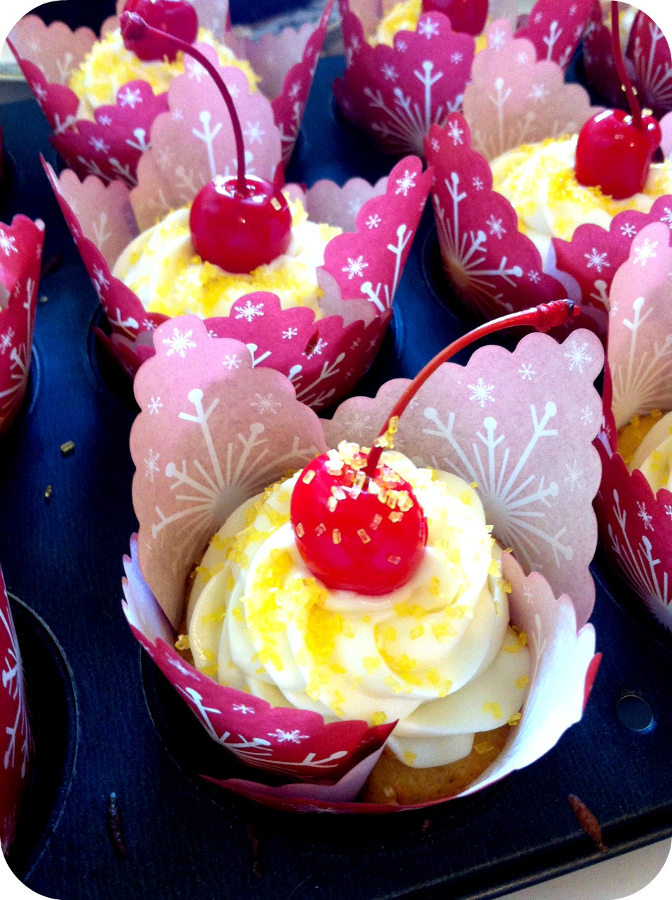 Pineapple cream cheese cupcakes with cherries.